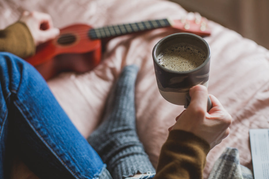 holding coffee in bed for depression